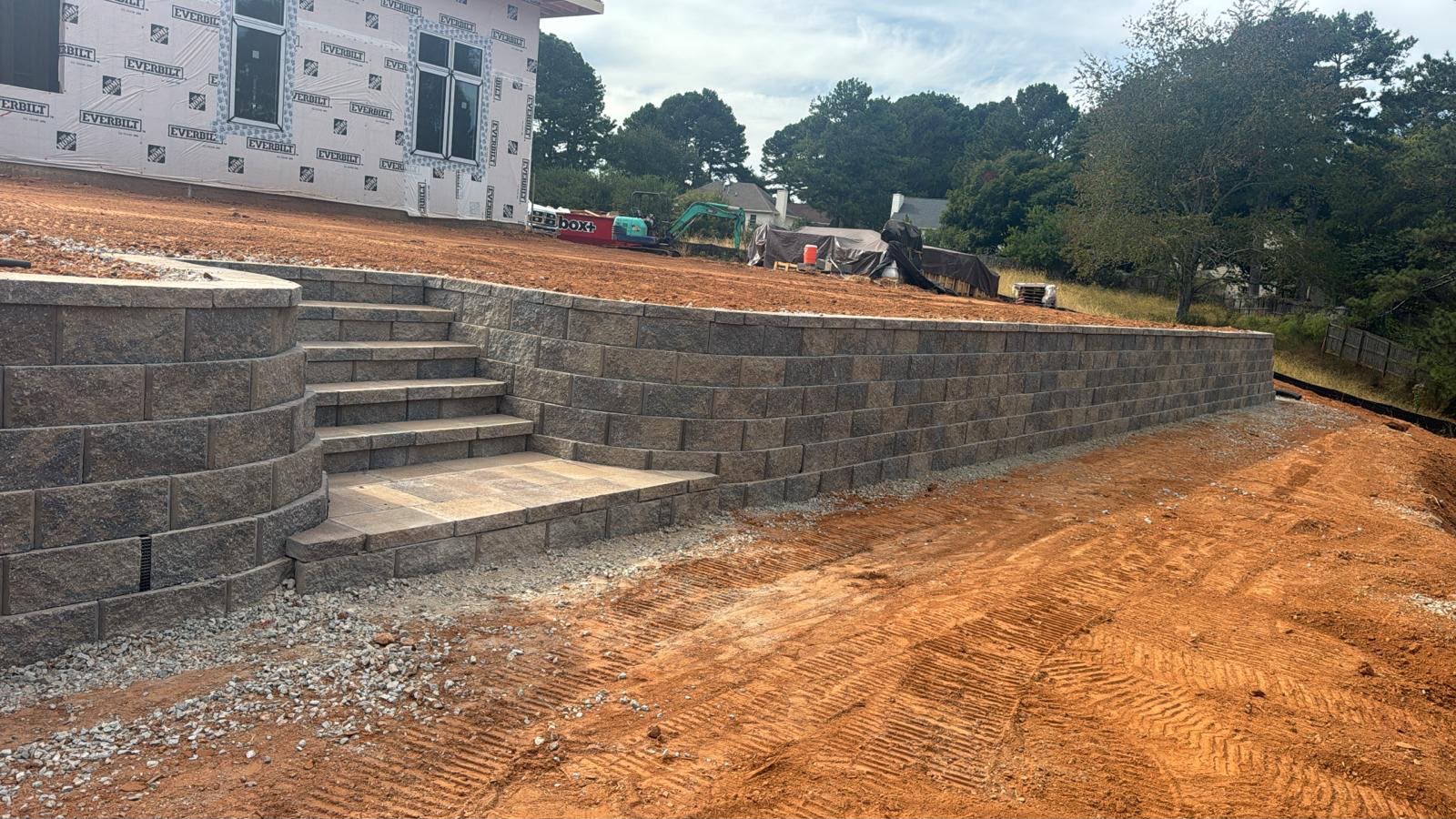 Segmental block retaining wall with integrated stone steps