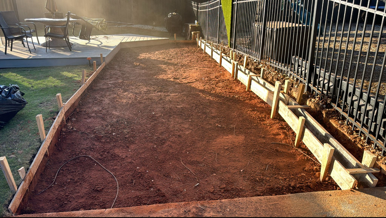 Walkway ground prep with red clay and wooden framing